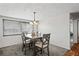 Dining room with gray table and chairs, hardwood floors at 3423 Umber Rd, Holiday, FL 34691