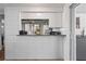 Kitchen pass-through with granite countertop and white tile at 3423 Umber Rd, Holiday, FL 34691