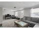 Spacious living room featuring a gray sofa and ample natural light at 3423 Umber Rd, Holiday, FL 34691