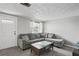 Bright living room with gray sectional sofa and coffee table at 3423 Umber Rd, Holiday, FL 34691