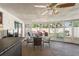 Relaxing sunroom with wicker furniture and pool views at 3423 Umber Rd, Holiday, FL 34691