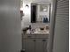 Clean bathroom with a vanity, mirror, and shower at 4412 Floramar Ter, New Port Richey, FL 34652