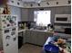 Well-equipped kitchen featuring gray cabinets and modern appliances at 4412 Floramar Ter, New Port Richey, FL 34652