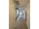 View down a hallway showcasing tile floors and access to other rooms at 4933 Filner St # 4933, New Port Richey, FL 34652