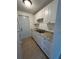 Bright kitchen with white cabinets, granite counters, and tile floors at 4933 Filner St # 4933, New Port Richey, FL 34652