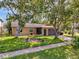 House exterior with landscaping and driveway at 10824 Peppertree Ln, Port Richey, FL 34668