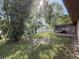 Backyard with screened porch and lush greenery at 10824 Peppertree Ln, Port Richey, FL 34668