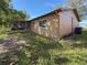 Tan house exterior with screened porch and yard at 10824 Peppertree Ln, Port Richey, FL 34668