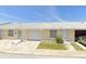 Tan, two-unit building with garage doors and landscaping at 4933 Filner St # 4933, New Port Richey, FL 34652