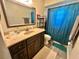 Bathroom featuring a vanity, mirror, toilet, and shower with a curtain at 10521 Mira Vista Dr, Port Richey, FL 34668