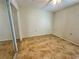 Bright bedroom featuring neutral walls, vinyl flooring, and a mirrored closet at 10521 Mira Vista Dr, Port Richey, FL 34668