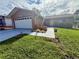 Inviting single-story home with a well-maintained lawn, shrubs, and a driveway leading to the attached garage at 10521 Mira Vista Dr, Port Richey, FL 34668