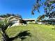 Charming home with an attached garage and a lush green lawn at 10521 Mira Vista Dr, Port Richey, FL 34668