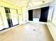 The sunroom includes sliding glass doors and lots of natural light at 10521 Mira Vista Dr, Port Richey, FL 34668