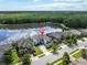 Scenic aerial view of the property highlighting the lakefront location and lush green surroundings at 12135 Crestridge Loop, Trinity, FL 34655