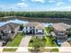 Expansive aerial view of the home showcasing the well-manicured lawn, lake view, and surrounding neighborhood at 12135 Crestridge Loop, Trinity, FL 34655