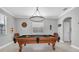 Game room showcasing a pool table, crown molding, modern chandelier, and stylish decor for entertaining guests at 12135 Crestridge Loop, Trinity, FL 34655