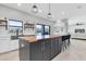 Bright kitchen boasts a butcher block island, stainless sink, and views overlooking the water at 12135 Crestridge Loop, Trinity, FL 34655
