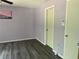 This bedroom features wood-look floors and a neutral color palette for a calming atmosphere at 3018 Greynolds Ave, Spring Hill, FL 34608