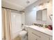 Bright bathroom features a shower-tub combination, modern vanity and neutral decor at 4041 Las Vegas Dr, New Port Richey, FL 34653