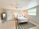 Cozy bedroom with neutral walls, tile floor, ceiling fan and natural light from the window at 4041 Las Vegas Dr, New Port Richey, FL 34653