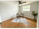 Bedroom with wood laminate flooring, ceiling fan, and a desk by the window for natural light at 4041 Las Vegas Dr, New Port Richey, FL 34653