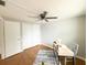 Bedroom with wood laminate floor and ceiling fan features a desk for optimal productivity at 4041 Las Vegas Dr, New Port Richey, FL 34653
