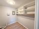 Spacious walk-in closet with laminate flooring and ample built-in shelving for organized storage at 4041 Las Vegas Dr, New Port Richey, FL 34653