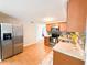 Well-lit kitchen featuring stainless steel appliances, wooden cabinets, and mosaic backsplash at 4041 Las Vegas Dr, New Port Richey, FL 34653