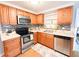 Well-equipped kitchen with stainless steel appliances, including a microwave and dishwasher, and mosaic backsplash at 4041 Las Vegas Dr, New Port Richey, FL 34653