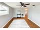 This living room features hardwood floors, ceiling fan, a decorative rug and flows into the rest of the home at 4041 Las Vegas Dr, New Port Richey, FL 34653