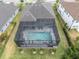 Aerial view of property featuring a screened-in pool area, well-maintained landscaping, and a serene setting at 6120 Marsh Trail Dr, Odessa, FL 33556