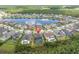 Aerial view of a luxury community with a lake, featuring a home with screened in pool at 6120 Marsh Trail Dr, Odessa, FL 33556