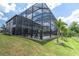 Stunning screened-in pool and backyard with a slide and lush landscaping, perfect for relaxation and outdoor activities at 6120 Marsh Trail Dr, Odessa, FL 33556