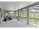 Large screened balcony with exercise equipment overlooking a wooded area provides a private retreat at 6120 Marsh Trail Dr, Odessa, FL 33556