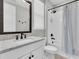 Bright bathroom with a modern vanity, marble countertop, and walk-in shower with tile surround at 6120 Marsh Trail Dr, Odessa, FL 33556