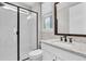 Stylish bathroom featuring a glass-enclosed shower and a granite vanity, blending luxury and functionality at 6120 Marsh Trail Dr, Odessa, FL 33556