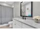 Modern bathroom with granite vanity, shower curtain, and elegant finishes, offering a spa-like experience at 6120 Marsh Trail Dr, Odessa, FL 33556