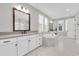 Bright bathroom with a corner soaking tub, double vanity, and marble floors at 6120 Marsh Trail Dr, Odessa, FL 33556