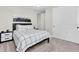 Well-lit bedroom with monochrome color scheme, large closet and a comfortable bed at 6120 Marsh Trail Dr, Odessa, FL 33556