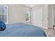 Comfortable bedroom with a blue bed, bright window, and closet, ideal for relaxation and privacy at 6120 Marsh Trail Dr, Odessa, FL 33556