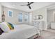 Serene bedroom features a white dresser, ceiling fan, and natural light, creating a relaxing ambiance at 6120 Marsh Trail Dr, Odessa, FL 33556