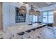 Stylish clubhouse bar featuring pendant lighting, modern seating, and a sleek countertop design at 6120 Marsh Trail Dr, Odessa, FL 33556