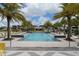 Resort-style community pool surrounded by palm trees and comfortable lounge chairs for relaxation at 6120 Marsh Trail Dr, Odessa, FL 33556
