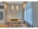 Bright dining area showcases modern lighting, comfortable bench seating, and a view of the outdoors at 6120 Marsh Trail Dr, Odessa, FL 33556
