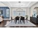 Dining room featuring a contemporary light fixture, area rug, and a stylish blue accent wall at 6120 Marsh Trail Dr, Odessa, FL 33556