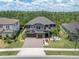Beautiful two-story home featuring a well-manicured front yard, a three-car garage and tile roof at 6120 Marsh Trail Dr, Odessa, FL 33556