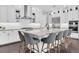 This kitchen features white cabinets, an island with bar stool seating, and stainless steel appliances at 6120 Marsh Trail Dr, Odessa, FL 33556