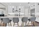 The kitchen features white cabinets, an island with bar stool seating and stainless steel appliances at 6120 Marsh Trail Dr, Odessa, FL 33556