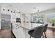 The kitchen features an island with bar stool seating and stainless steel appliances at 6120 Marsh Trail Dr, Odessa, FL 33556